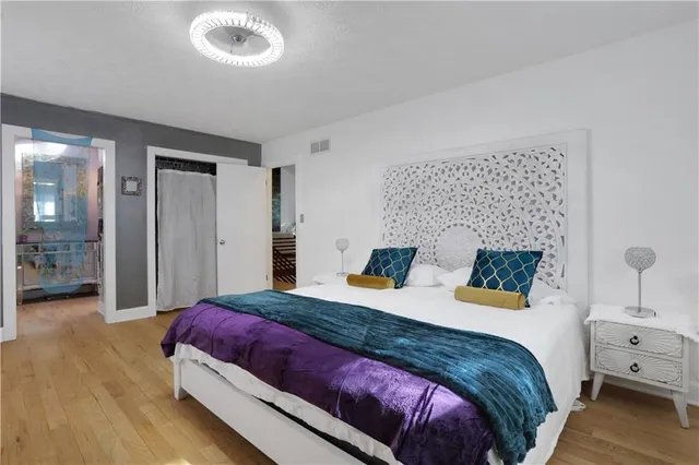 a spacious bedroom with a bed and a couch