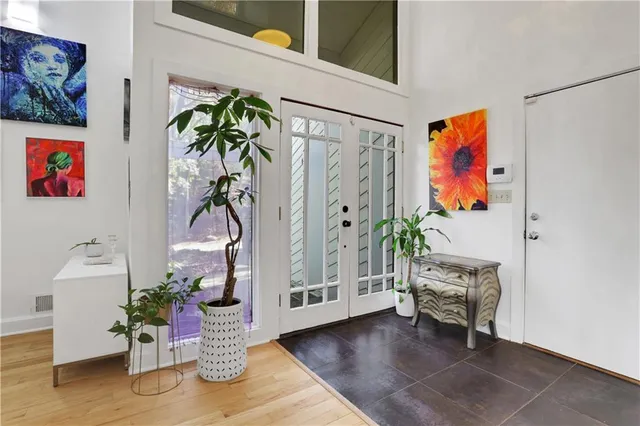 a living room with furniture and a potted plant