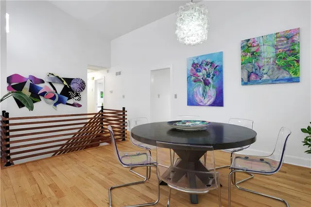 a dining room with furniture and wooden floor