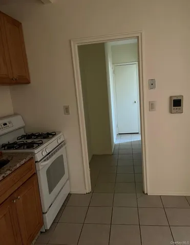 a kitchen with a stove top oven and cabinets