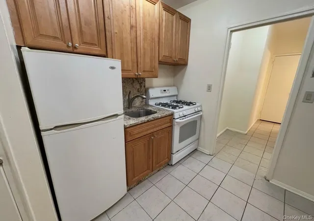 a kitchen with a refrigerator sink stove and cabinets