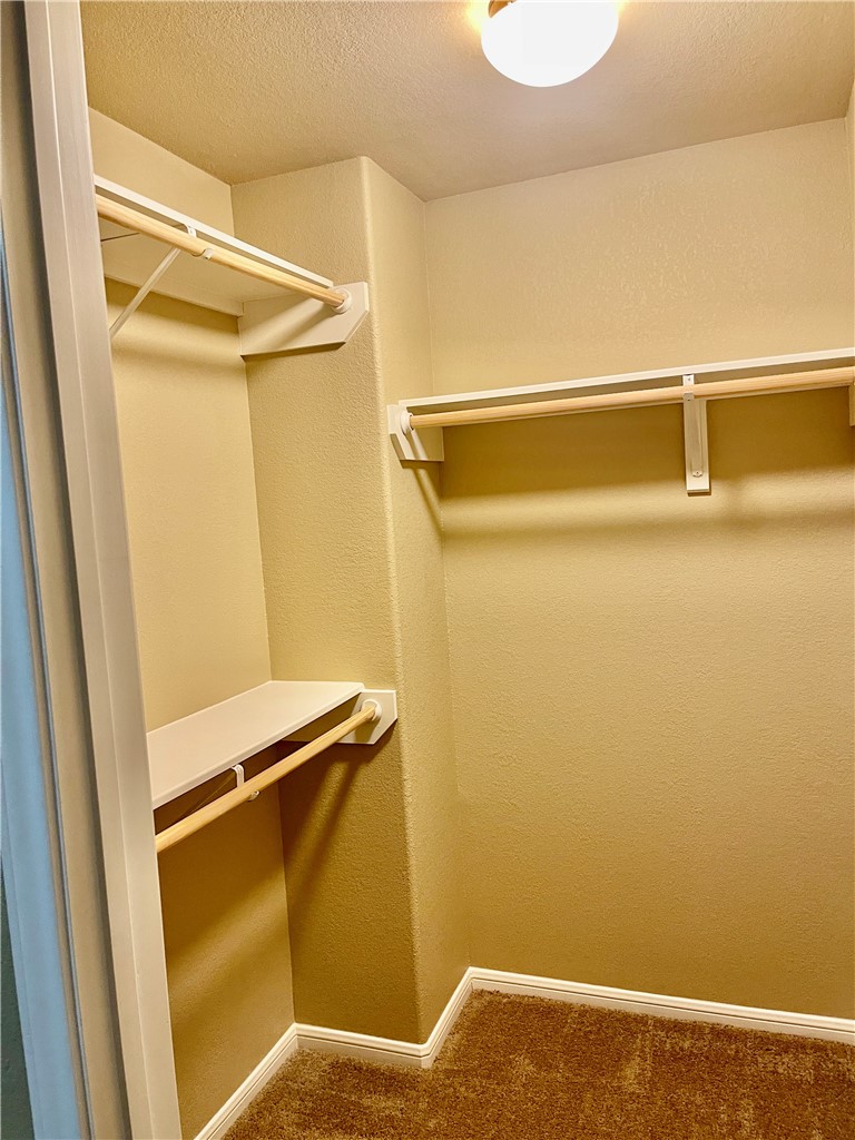 320 San Jose Street Portland, TX 78374 - Photo 19 of 23 a view of walk in closet with empty racks