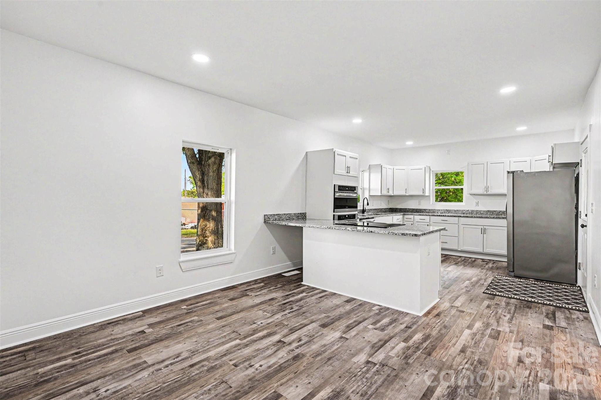 405 Aquadale Road Albemarle, NC 28001 - Photo 10 of 29 a kitchen with a refrigerator and a sink
