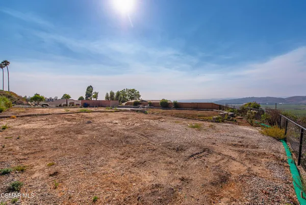 a view of a field with an ocean