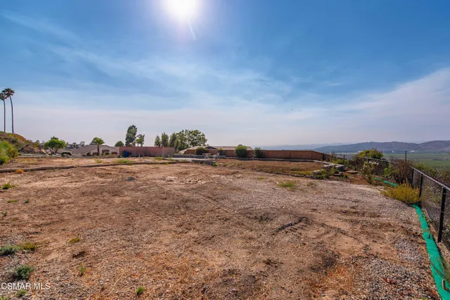 a view of a field with an ocean