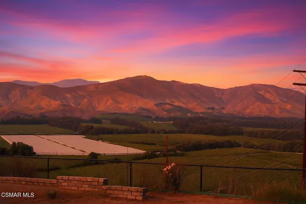 a view of a mountain with sunset view