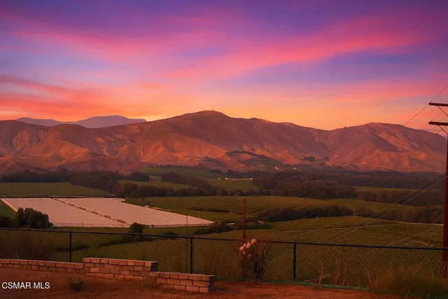 a view of a mountain with sunset view