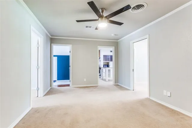an empty room with closet and ceiling fan