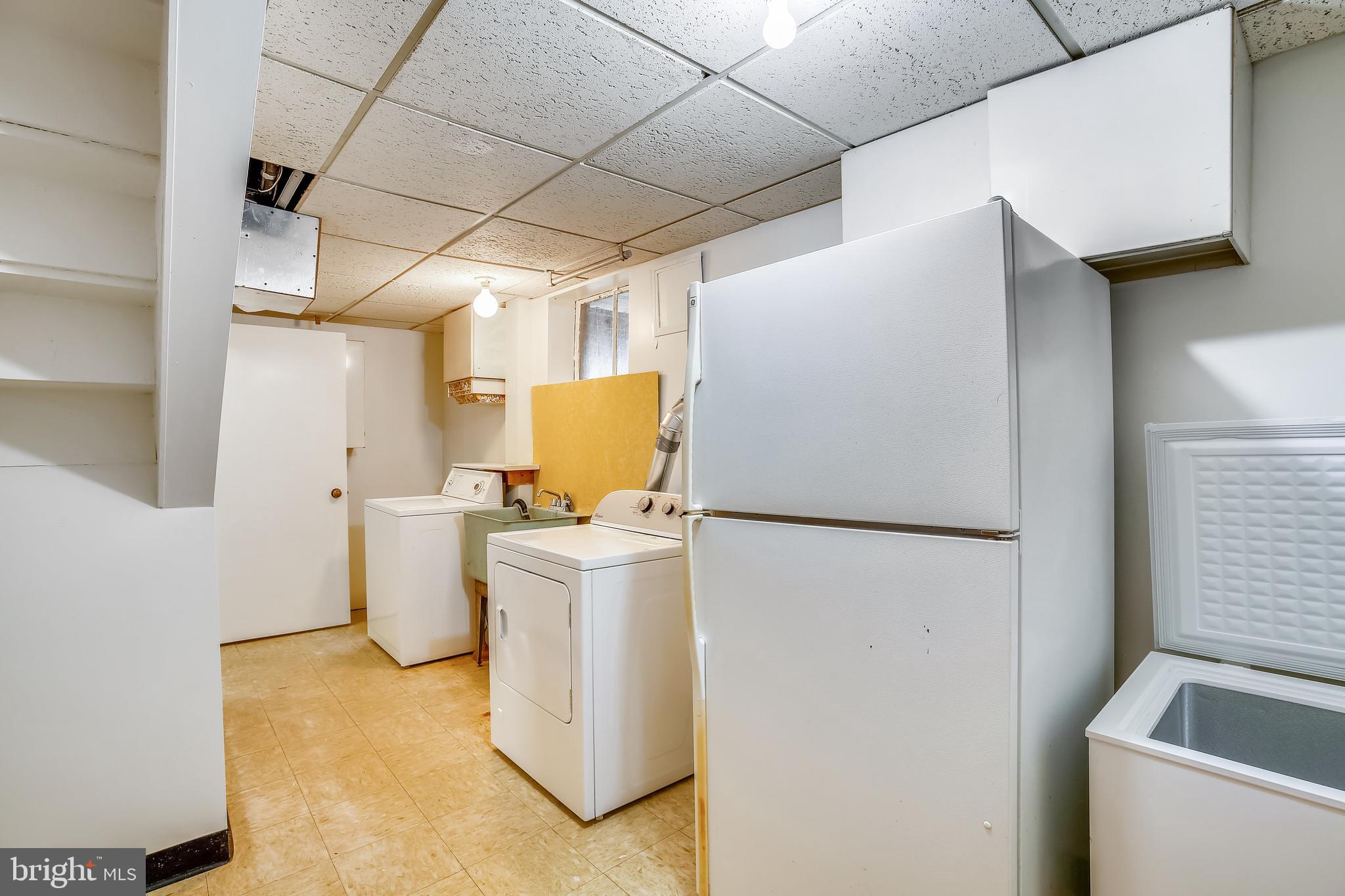 1002 Stirling Road Silver Spring, MD 20901 - Photo 28 of 39 Laundry room with storage and extra refrigerator.