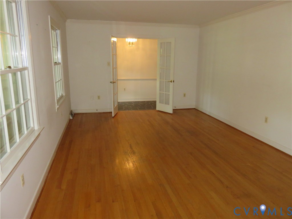 8379 Quailfield Road Mechanicsville, VA 23116 - Photo 17 of 56 an empty room with wooden floor and windows