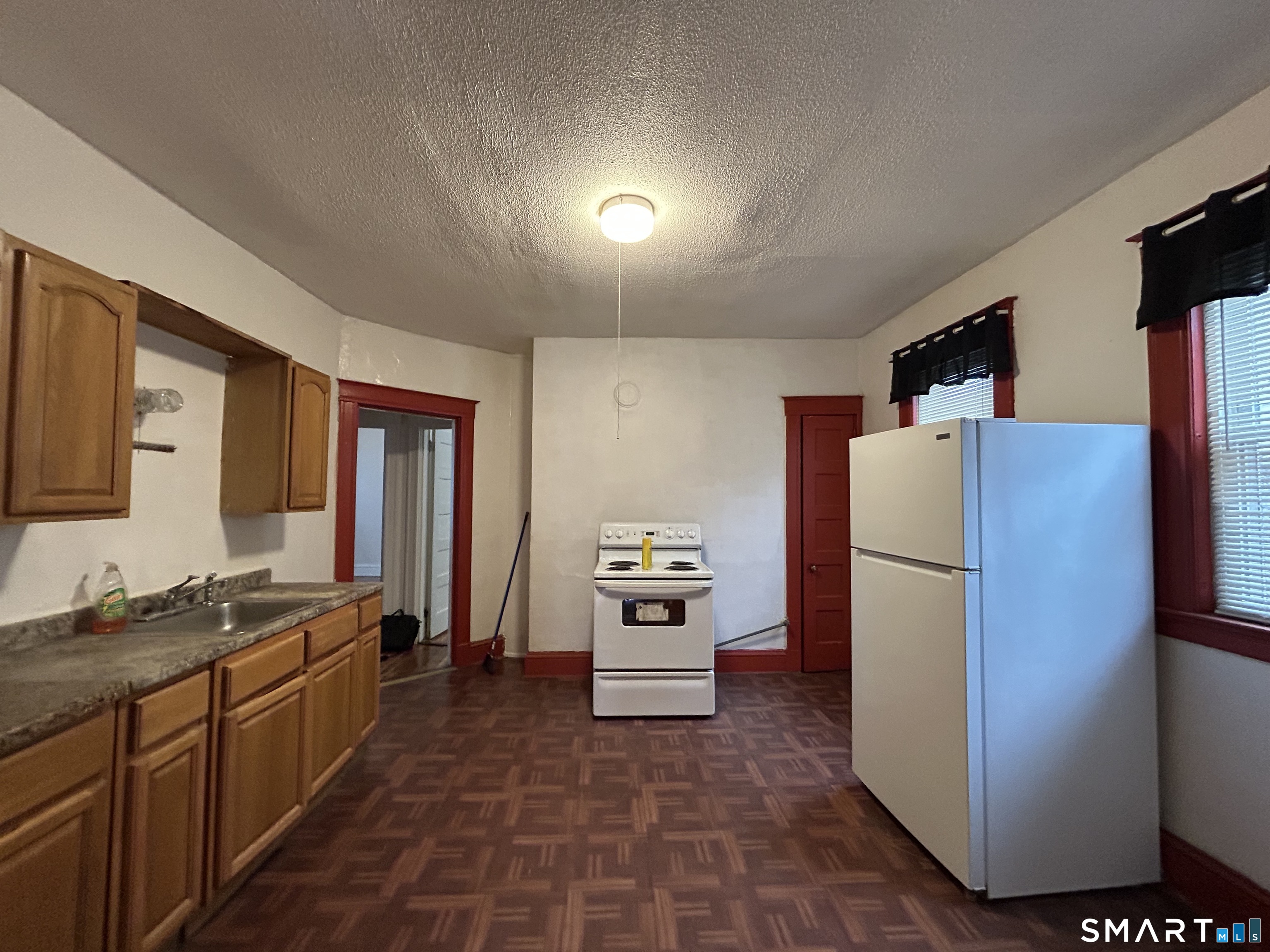 a kitchen with a refrigerator and a stove