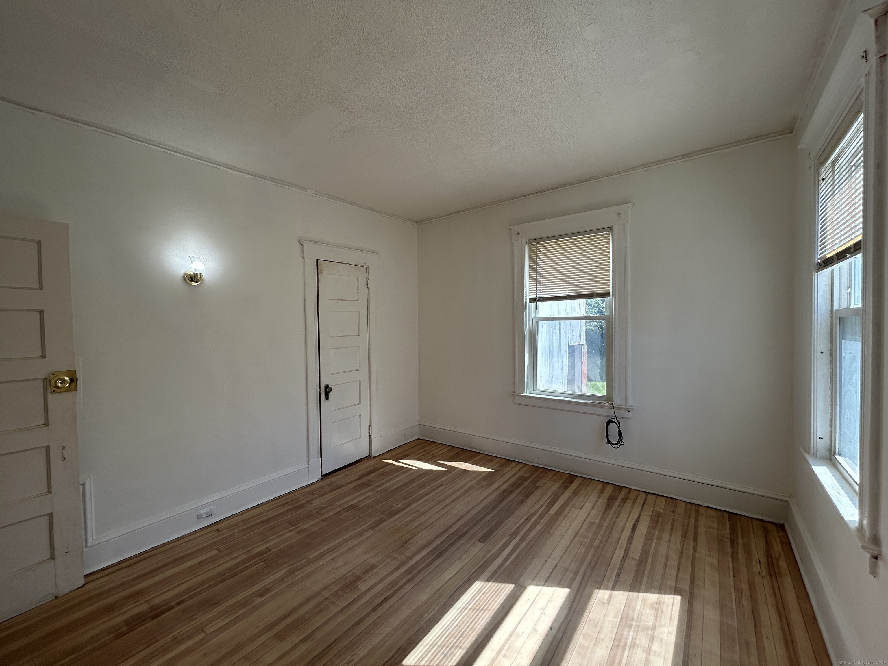 40 Cabot Street Hartford, CT 06112 - Photo 15 of 19 an empty room with wooden floor and windows