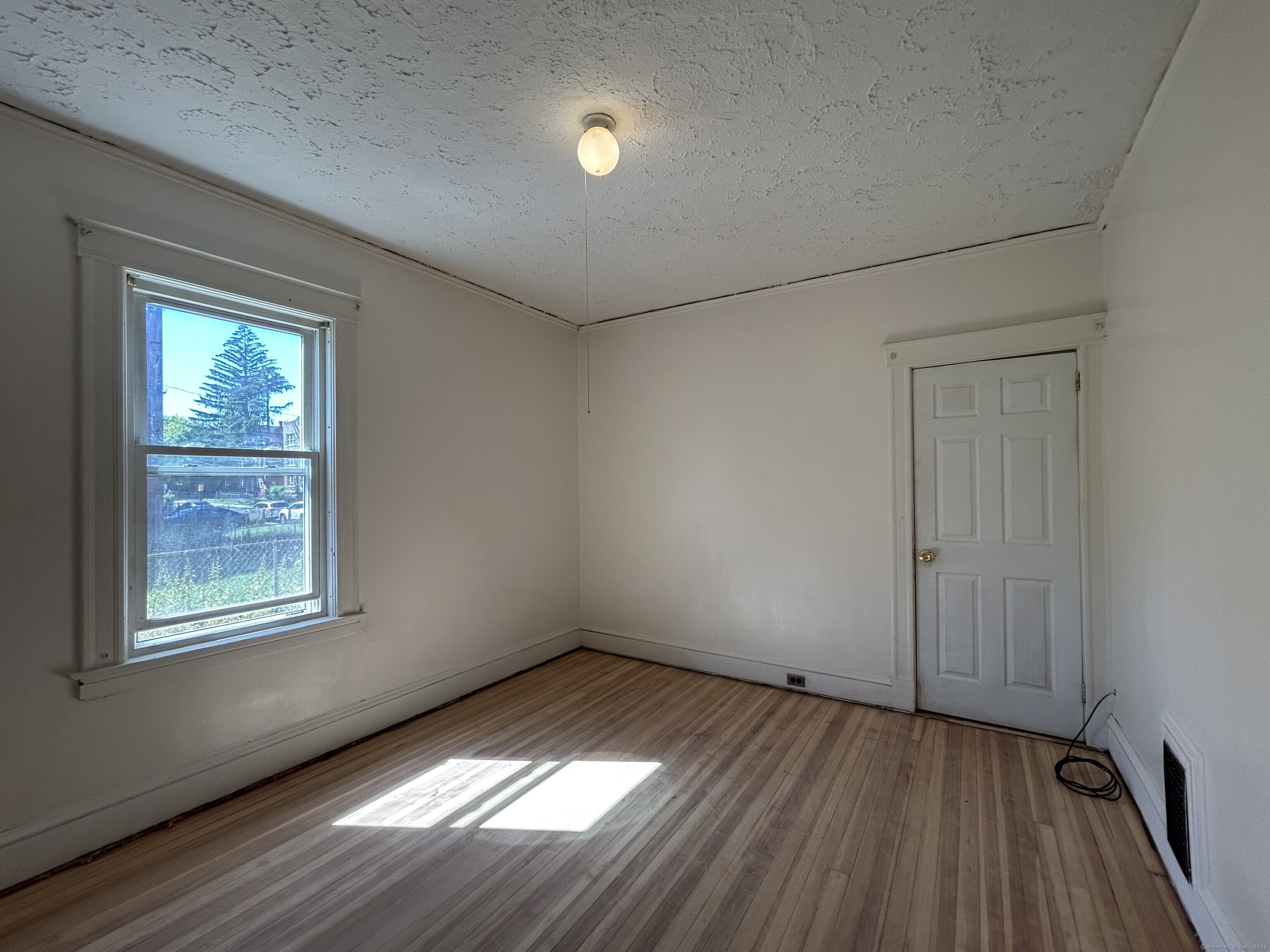 40 Cabot Street Hartford, CT 06112 - Photo 18 of 19 an empty room with wooden floor and windows