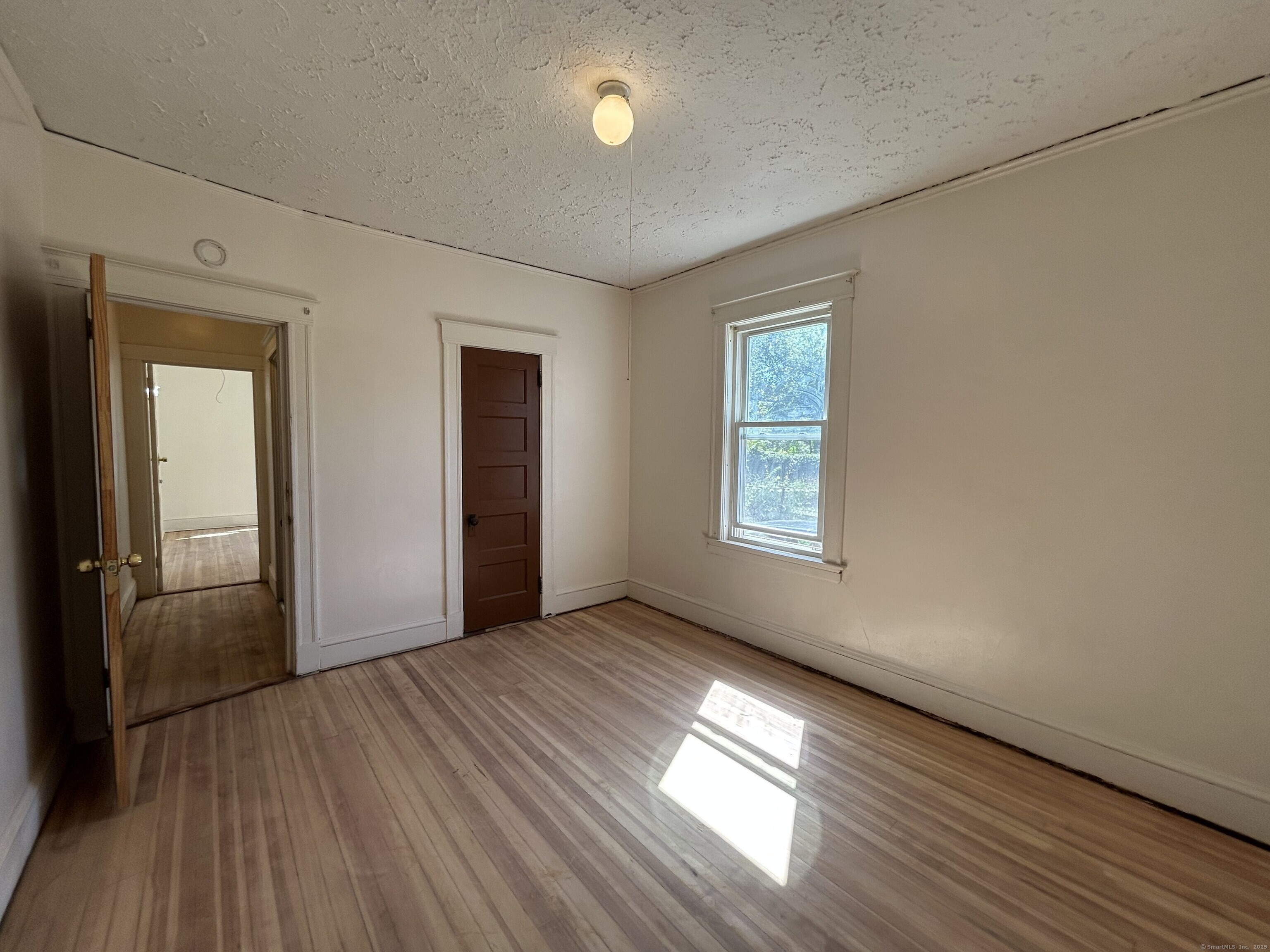40 Cabot Street Hartford, CT 06112 - Photo 19 of 19 an empty room with wooden floor and windows