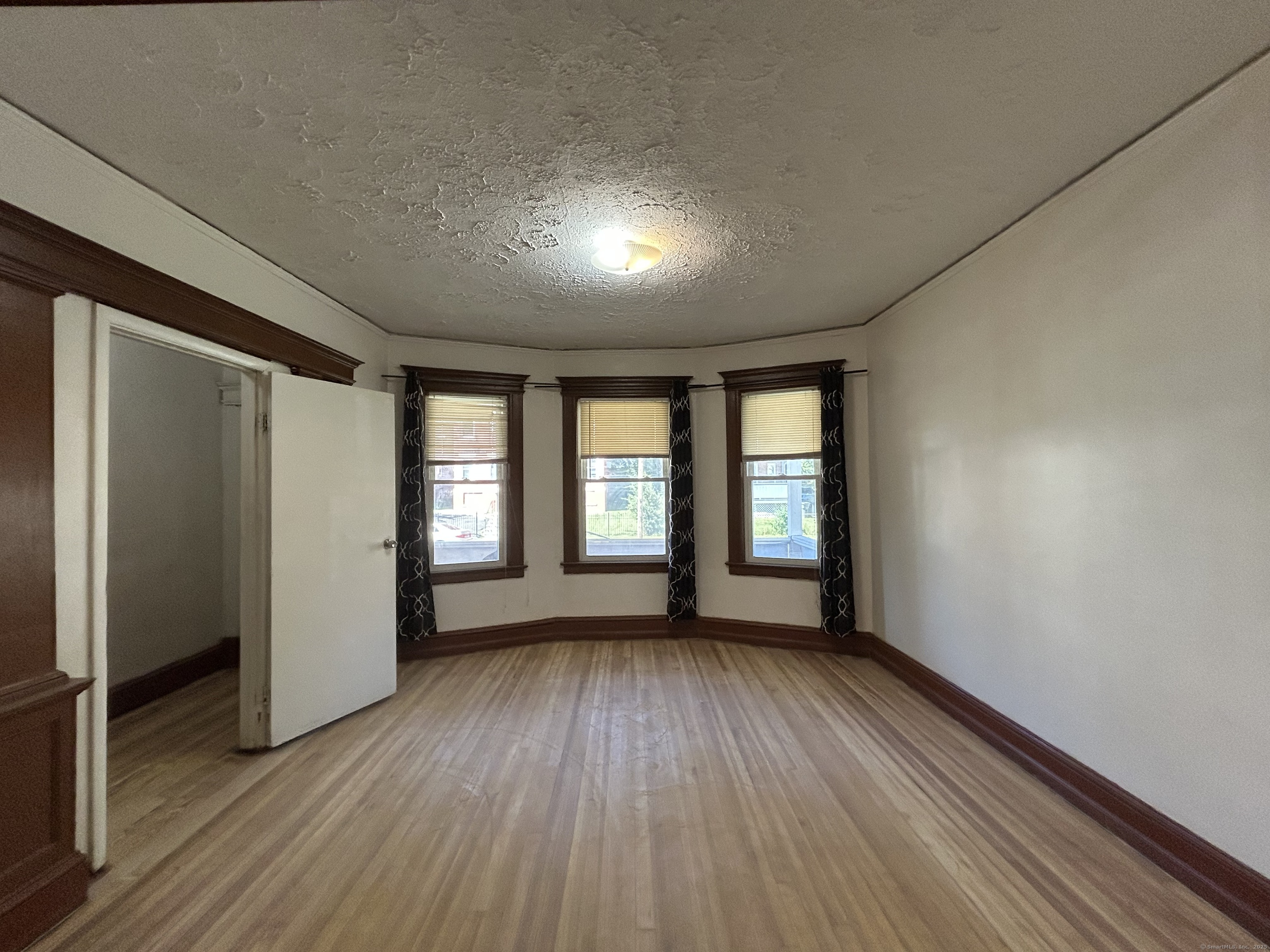 40 Cabot Street Hartford, CT 06112 - Photo 5 of 19 an empty room with wooden floor and windows