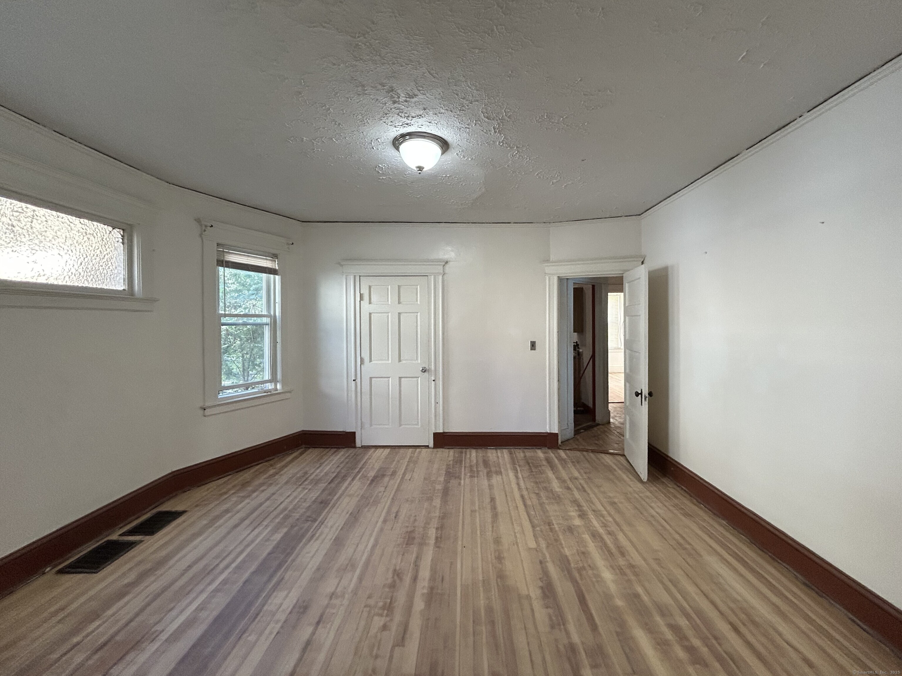 40 Cabot Street Hartford, CT 06112 - Photo 10 of 19 an empty room with wooden floor and windows