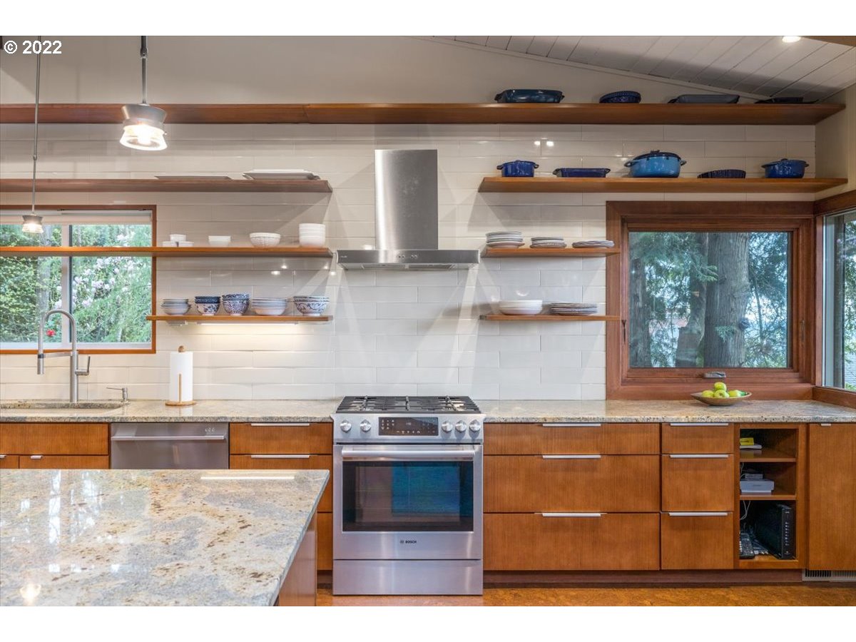 3837 Southwest Dosch Road Portland, OR 97239 - Photo 11 of 32 a kitchen with stainless steel appliances granite countertop a stove and a microwave