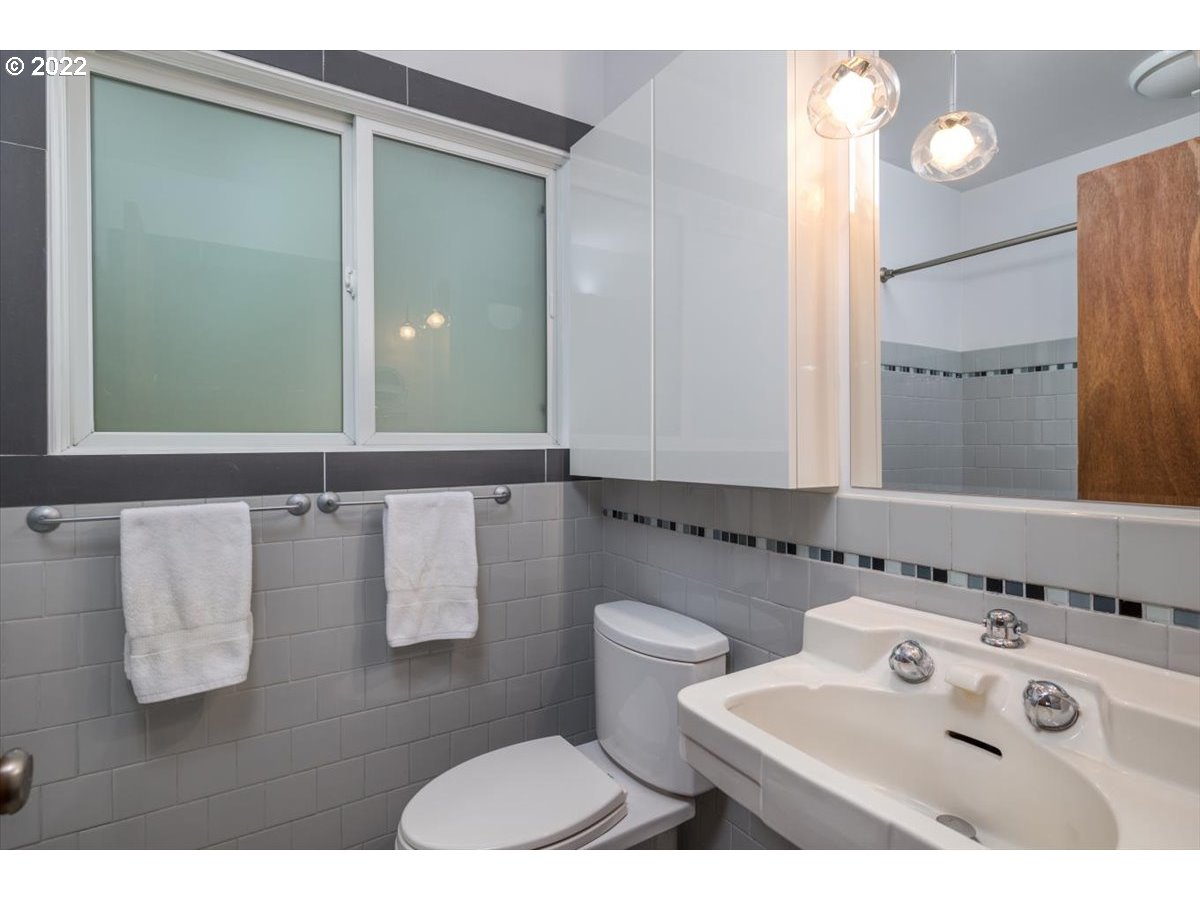 3837 Southwest Dosch Road Portland, OR 97239 - Photo 14 of 32 a bathroom with a sink and a mirror
