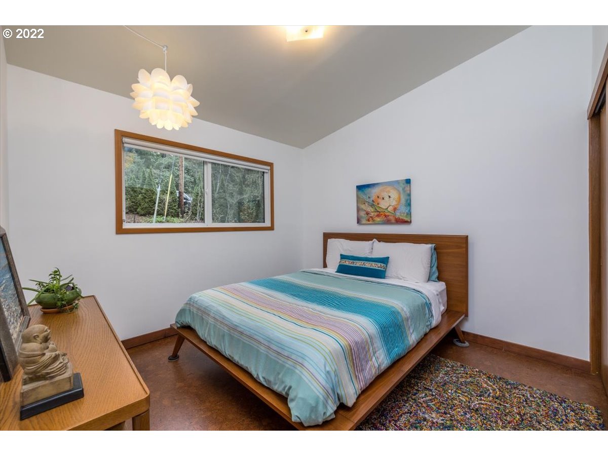3837 Southwest Dosch Road Portland, OR 97239 - Photo 15 of 32 a bedroom with a bed mirror and window
