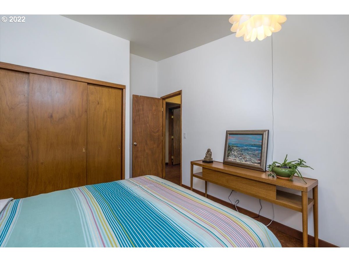 3837 Southwest Dosch Road Portland, OR 97239 - Photo 16 of 32 a bedroom with a bed and a table in it