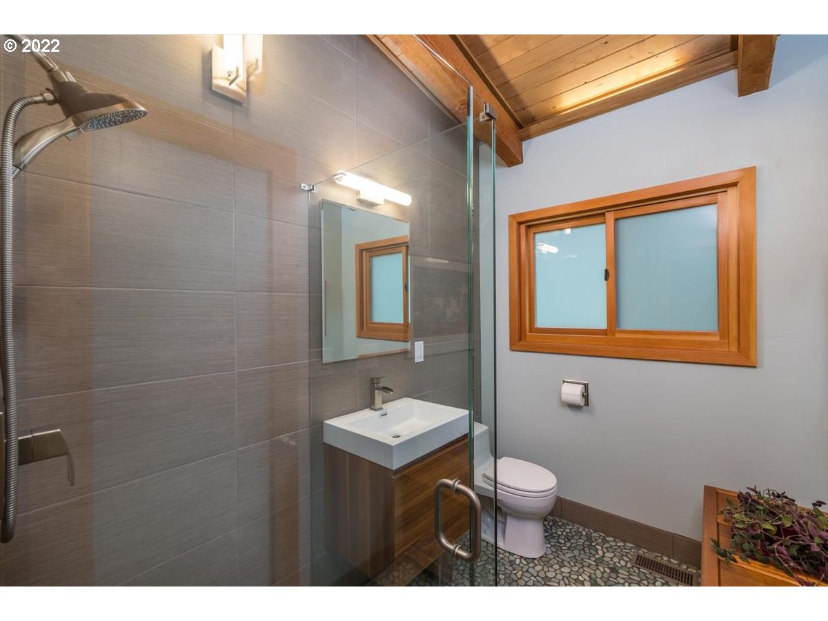 3837 Southwest Dosch Road Portland, OR 97239 - Photo 17 of 32 a bathroom with a toilet a sink and mirror