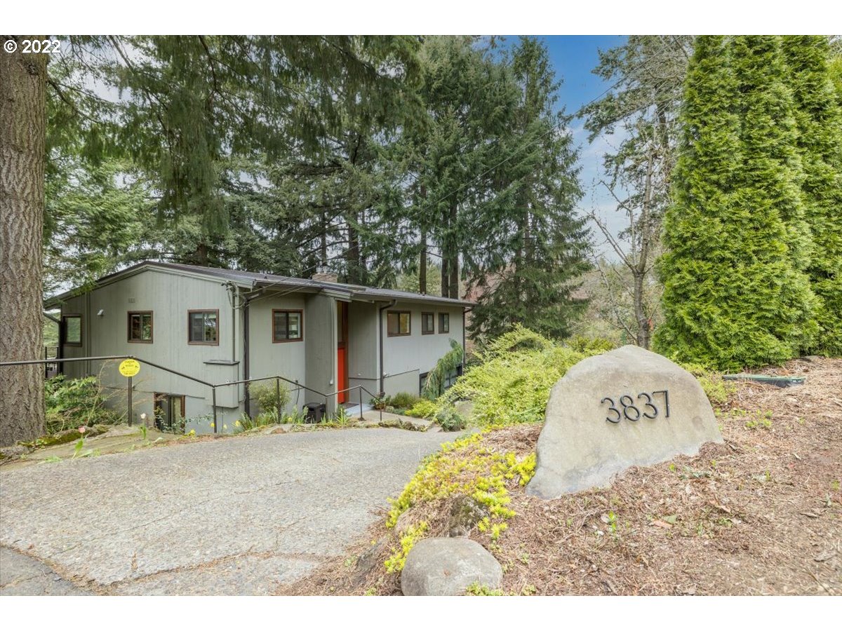 3837 Southwest Dosch Road Portland, OR 97239 - Photo 2 of 32 a front view of a house with a yard and garage