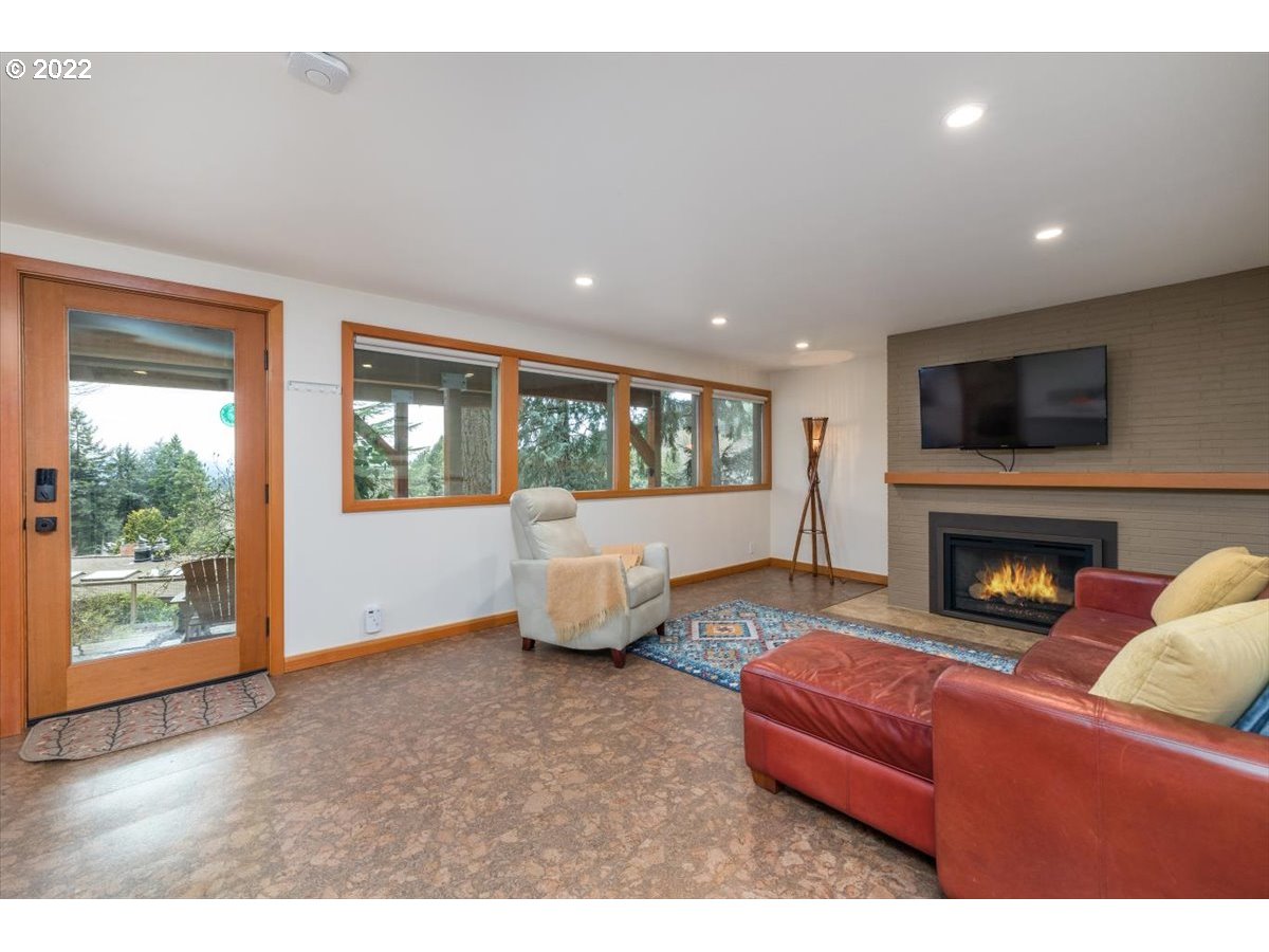 3837 Southwest Dosch Road Portland, OR 97239 - Photo 21 of 32 a living room with furniture wooden floor and a fireplace