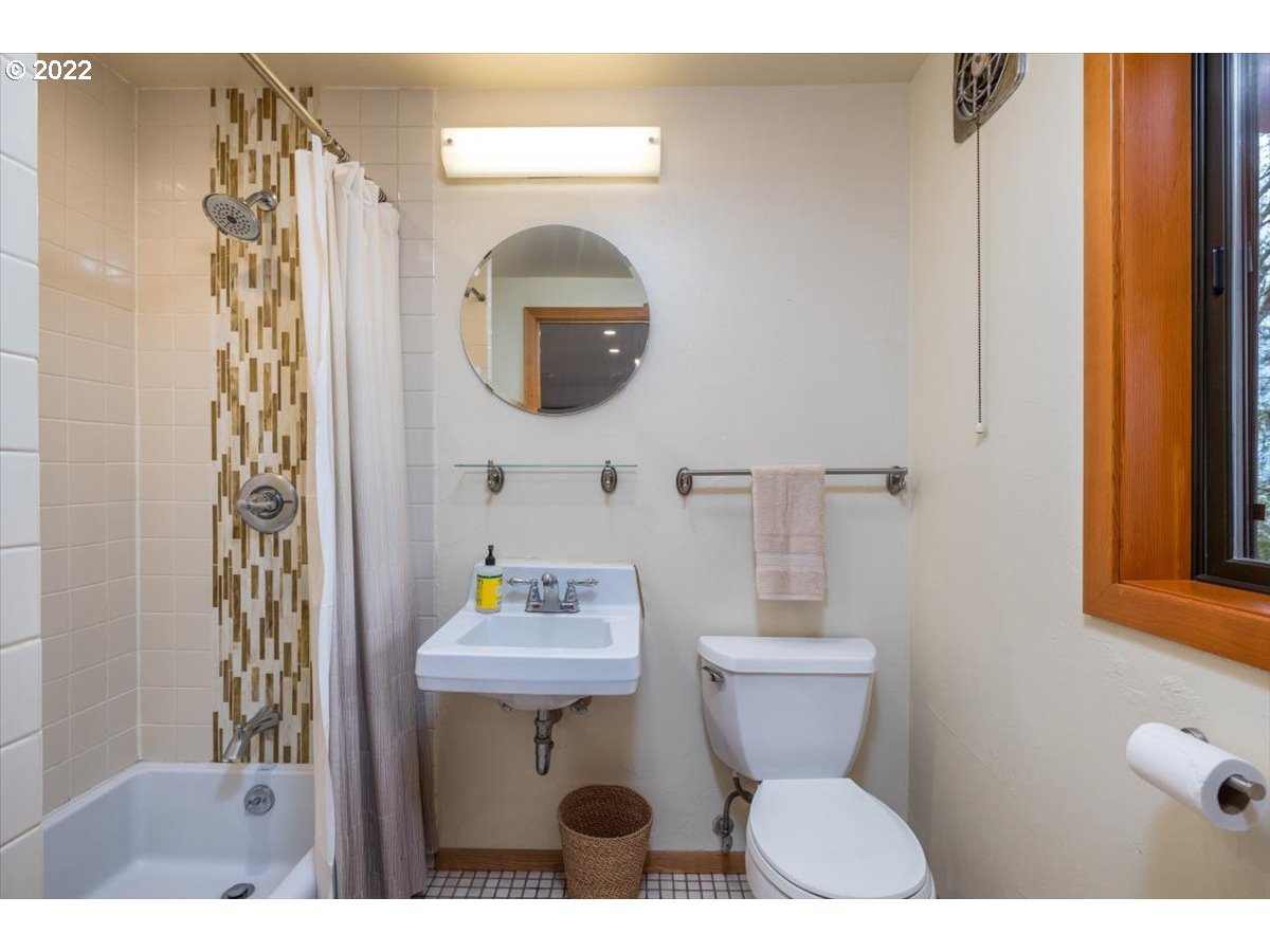 3837 Southwest Dosch Road Portland, OR 97239 - Photo 23 of 32 a bathroom with a sink mirror and toilet
