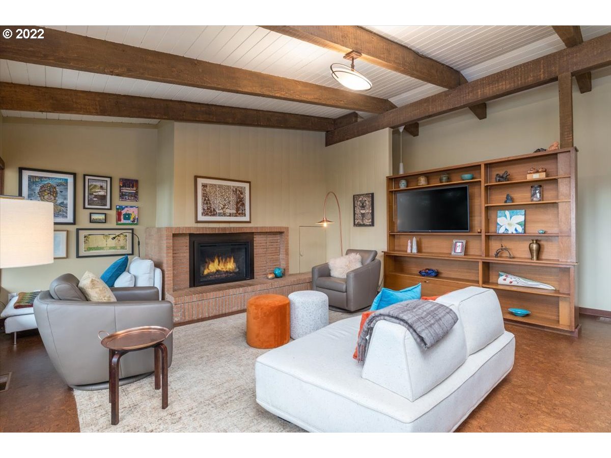 3837 Southwest Dosch Road Portland, OR 97239 - Photo 6 of 32 a living room with furniture a flat screen tv and a fireplace