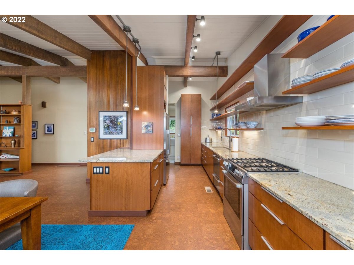 3837 Southwest Dosch Road Portland, OR 97239 - Photo 10 of 32 a kitchen with stainless steel appliances granite countertop a stove a sink and a refrigerator