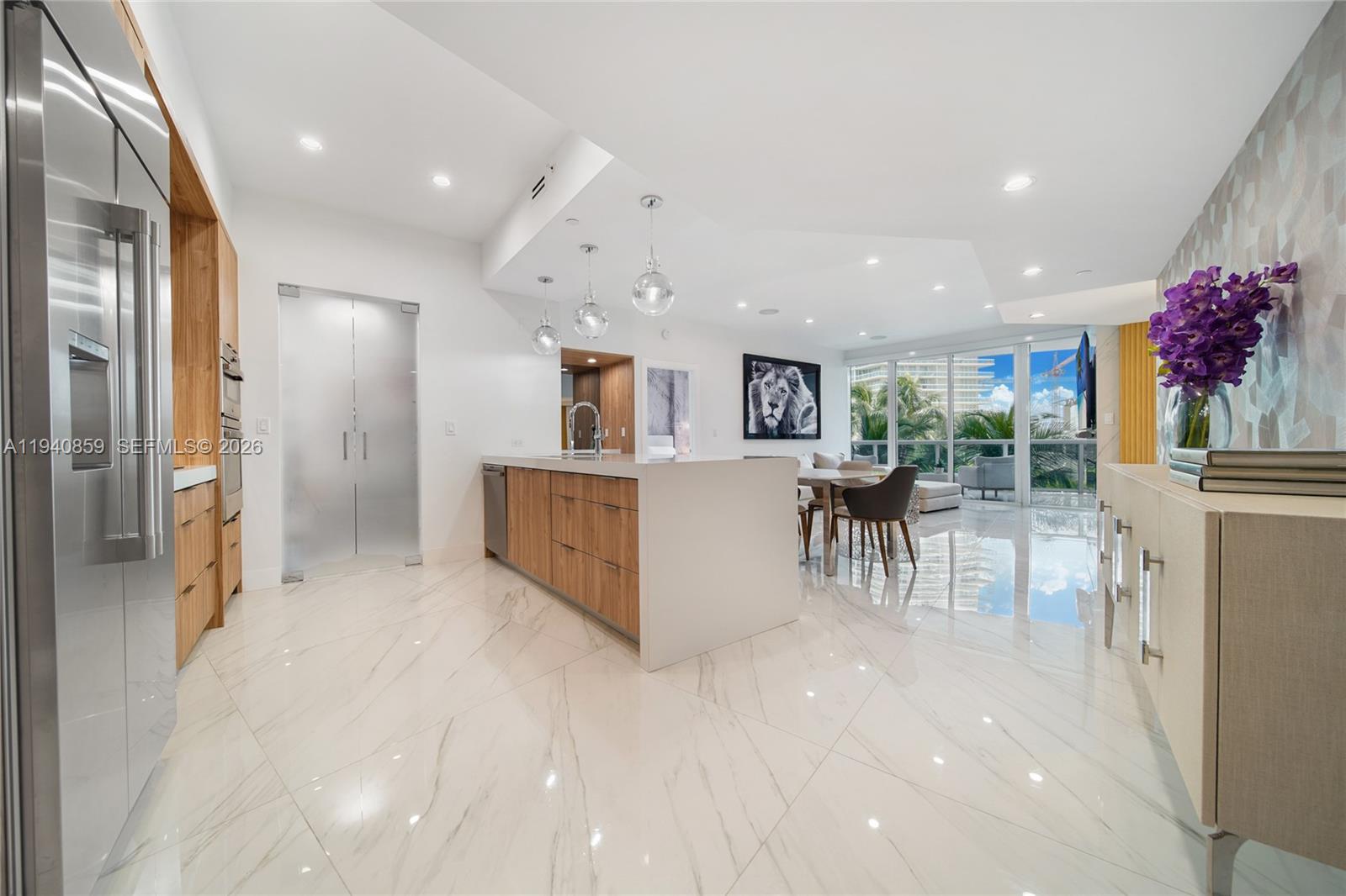 400 Alton Road, Unit 409 Miami Beach, FL 33139 - Photo 1 of 25 a view of kitchen with furniture and a refrigerator