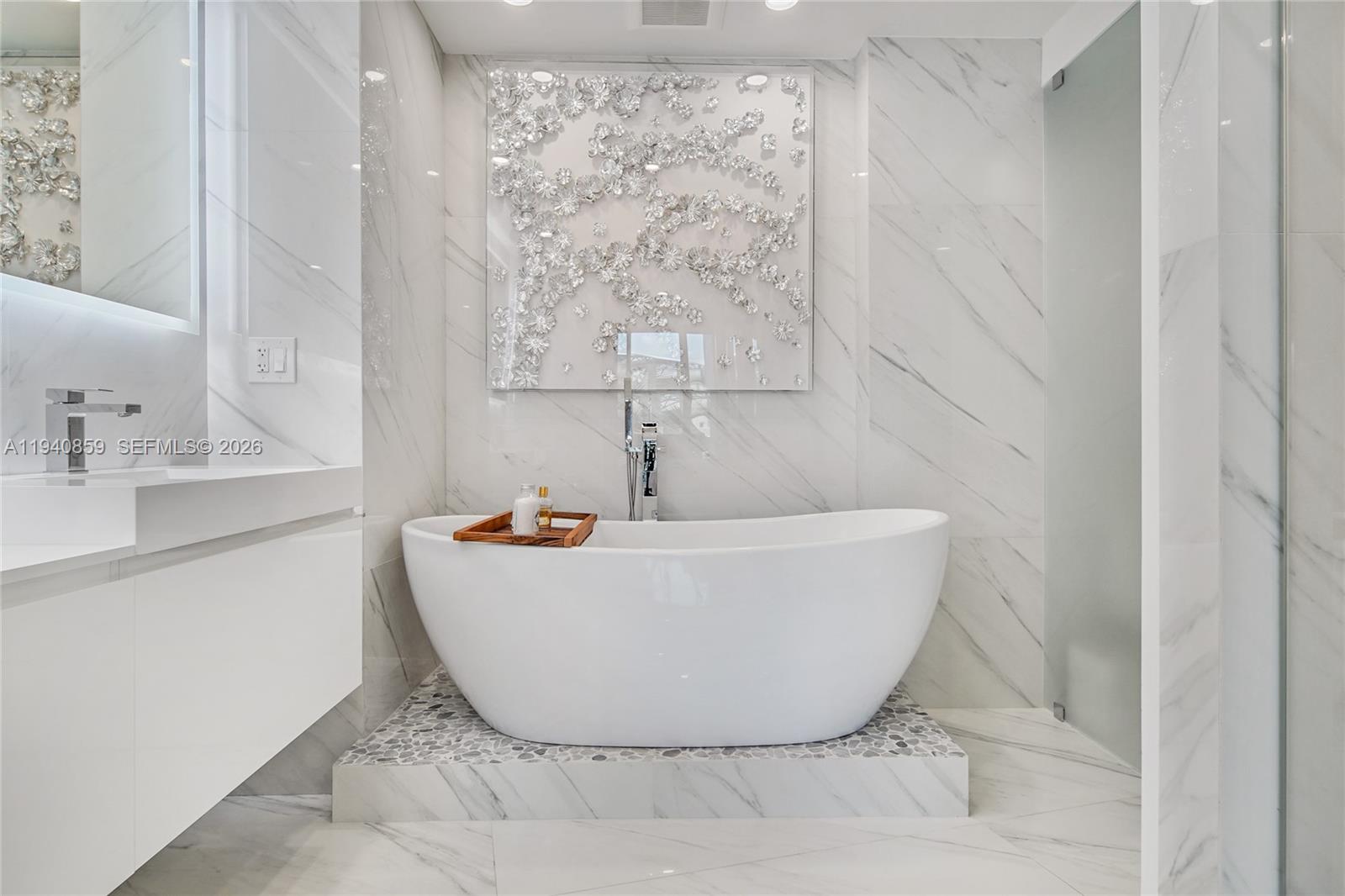 400 Alton Road, Unit 409 Miami Beach, FL 33139 - Photo 11 of 25 a white bath tub sitting in a bathroom