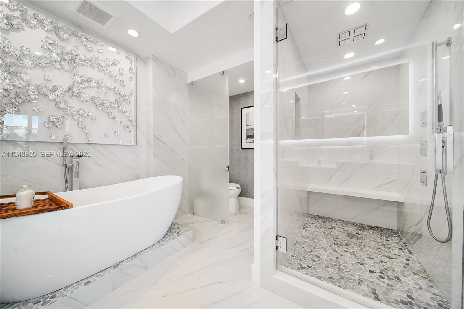 400 Alton Road, Unit 409 Miami Beach, FL 33139 - Photo 12 of 25 a bathroom with a bathtub and a shower