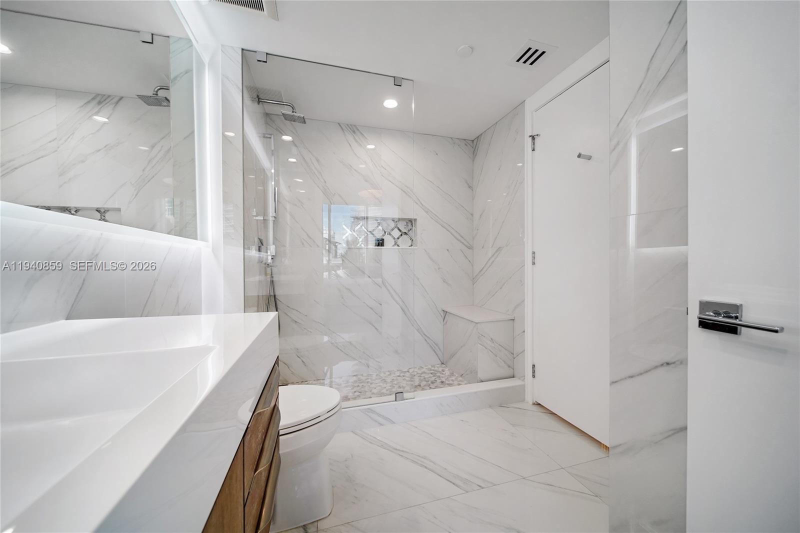 400 Alton Road, Unit 409 Miami Beach, FL 33139 - Photo 14 of 25 a bathroom with a bathtub and a shower