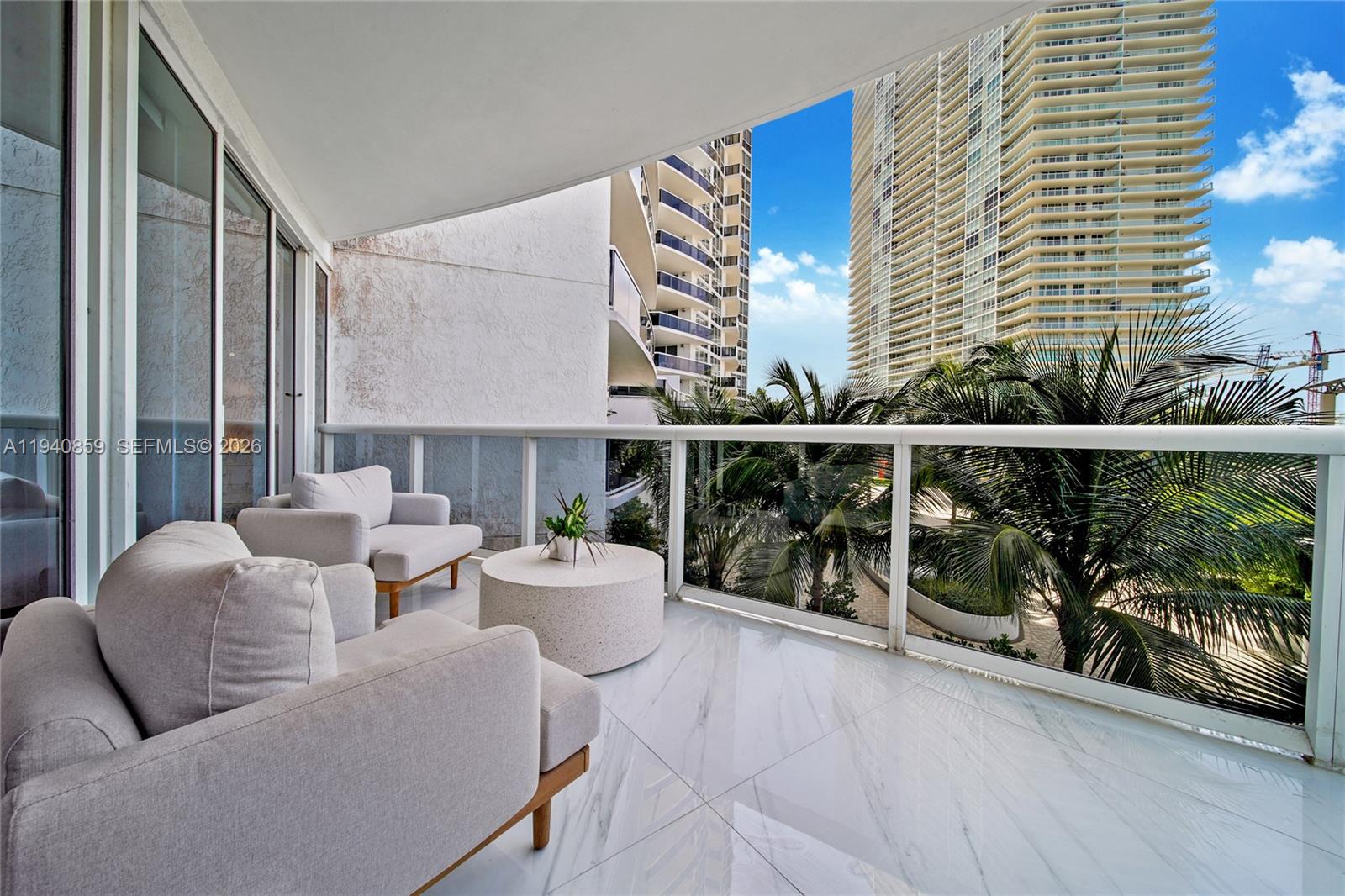 400 Alton Road, Unit 409 Miami Beach, FL 33139 - Photo 19 of 25 a view of a balcony with chairs and potted plants