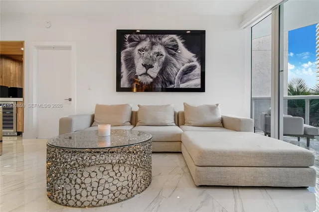 a living room with furniture a couch and a flat screen tv