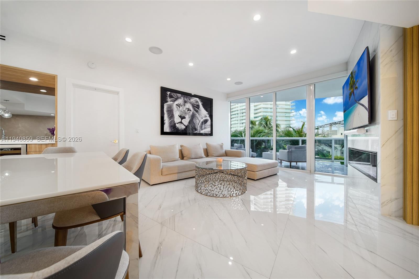 400 Alton Road, Unit 409 Miami Beach, FL 33139 - Photo 4 of 25 a living room with fireplace furniture and a large window