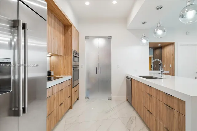 a kitchen with stainless steel appliances a refrigerator and a sink