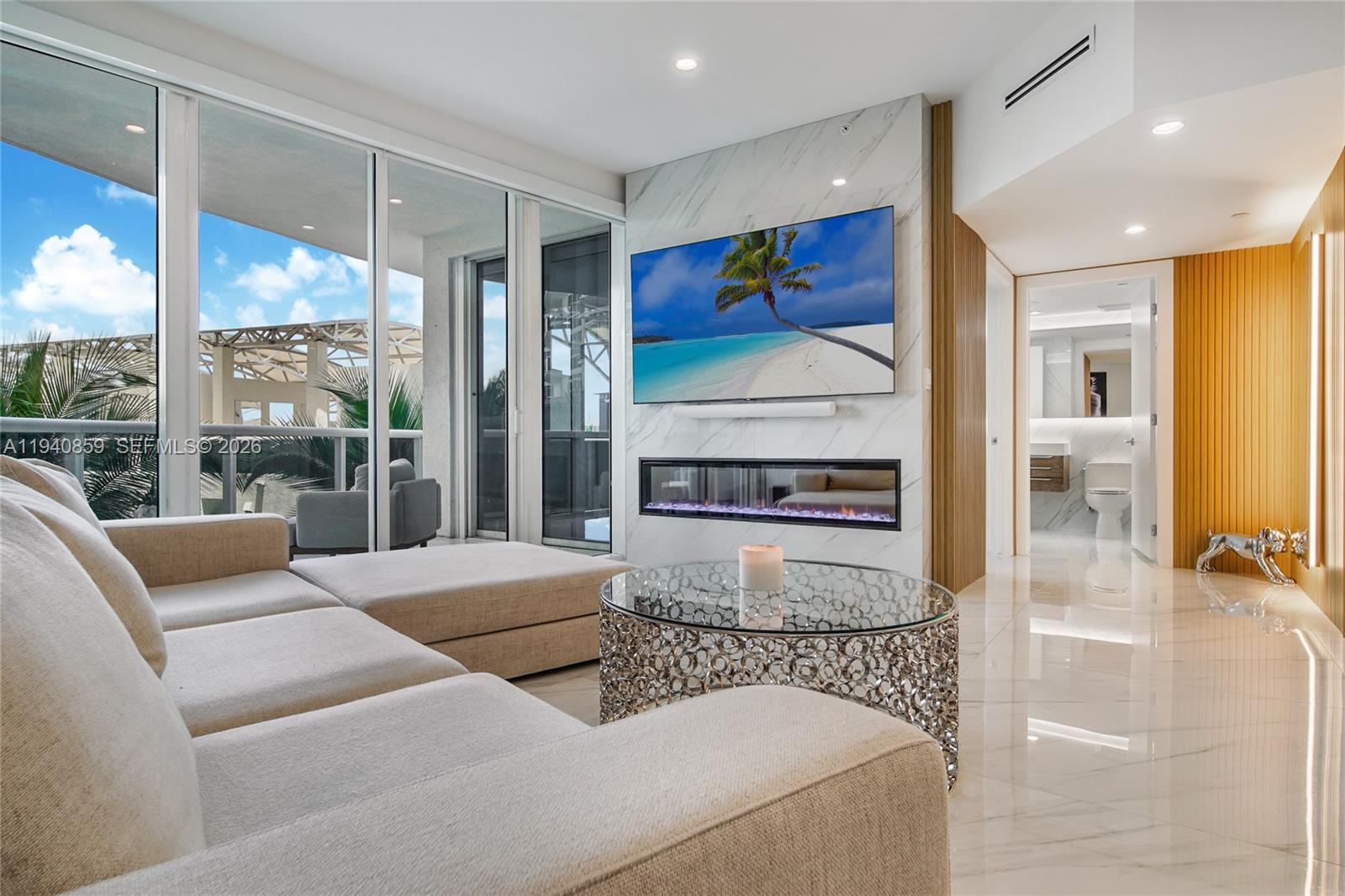 400 Alton Road, Unit 409 Miami Beach, FL 33139 - Photo 7 of 25 a living room with furniture and a flat screen tv