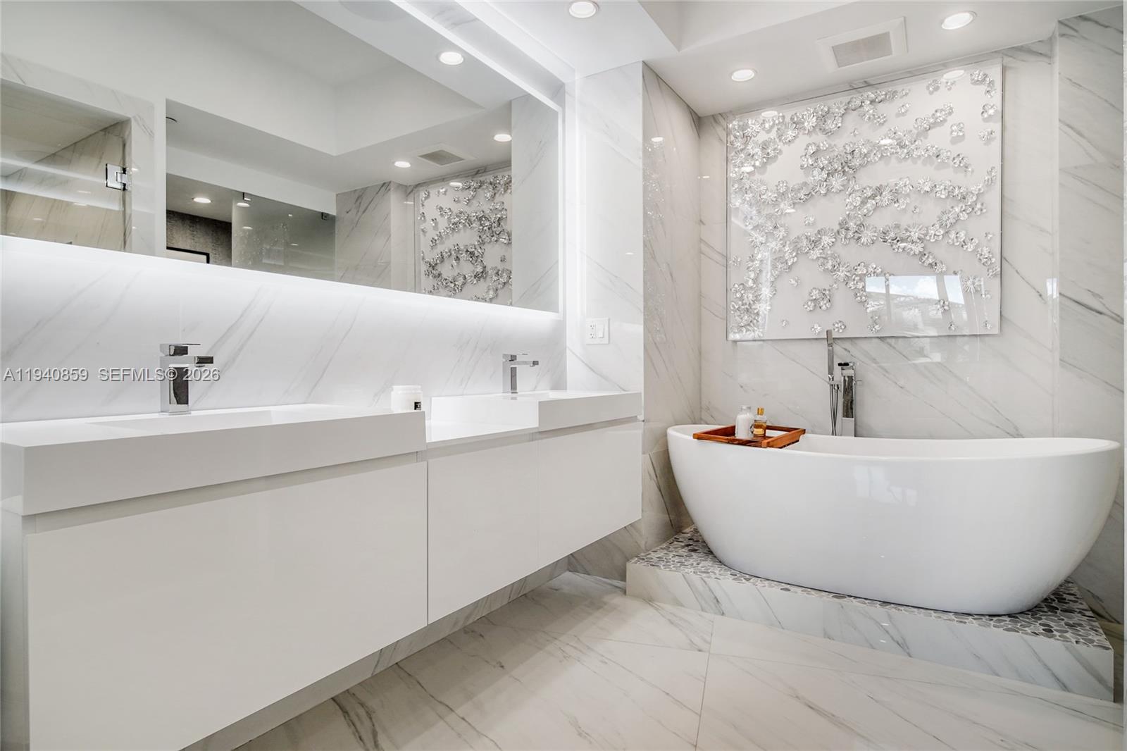 400 Alton Road, Unit 409 Miami Beach, FL 33139 - Photo 10 of 25 a bathroom with a bathtub and a sink