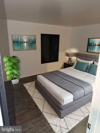 a bedroom with a bed and a potted plant