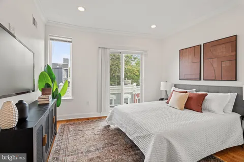a bedroom with a bed potted plant and a window