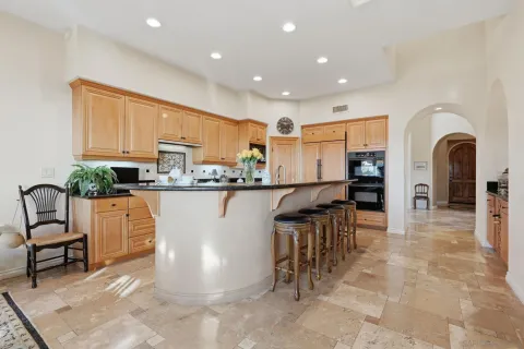 a kitchen with stainless steel appliances granite countertop a stove sink and cabinets