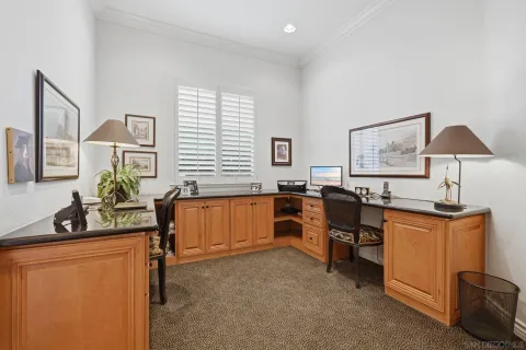 a bedroom with a bed mirror and window