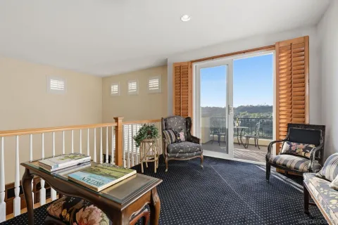 a view of a porch with furniture and floor to ceiling window