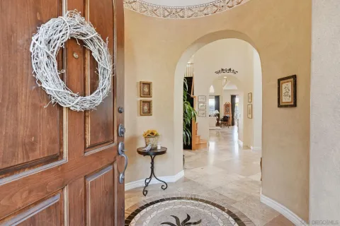 a view of a dining room with furniture and chandelier