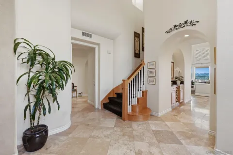 a view of a dining room with furniture and a chandelier