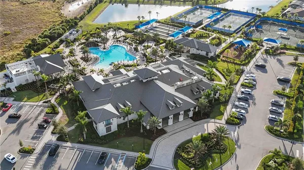 a view of a livingroom with furniture a chandelier and wooden floor