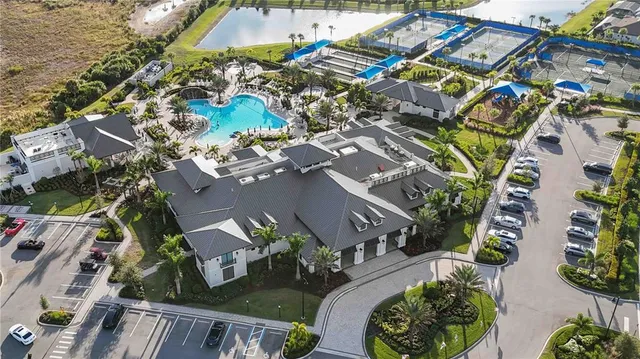 a view of a livingroom with furniture a chandelier and wooden floor