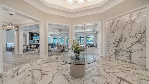 a living room with lots of furniture and a chandelier